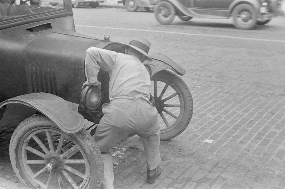 Just start the next iteration A man hand-cranking a stalled Model T on a brick street, 1938